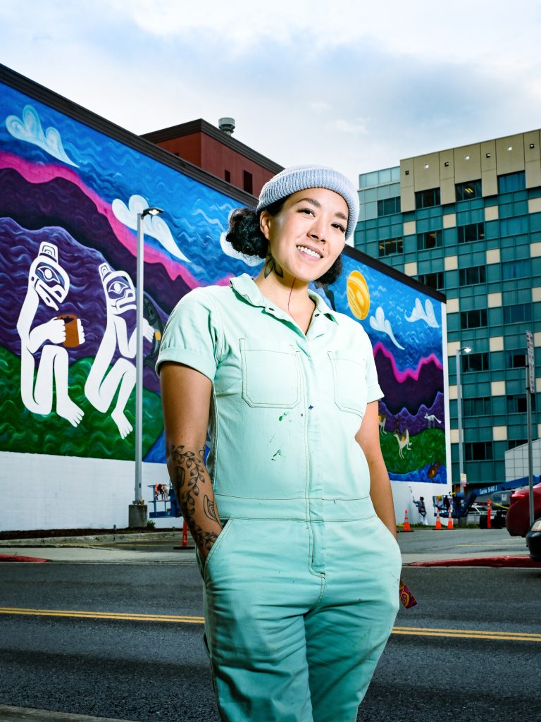 Worl with her mural in Anchorage, courtesy of Worl & Charles Tice