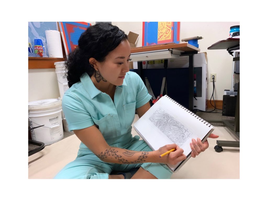 Worl designing a previous mural, courtesy of Worl